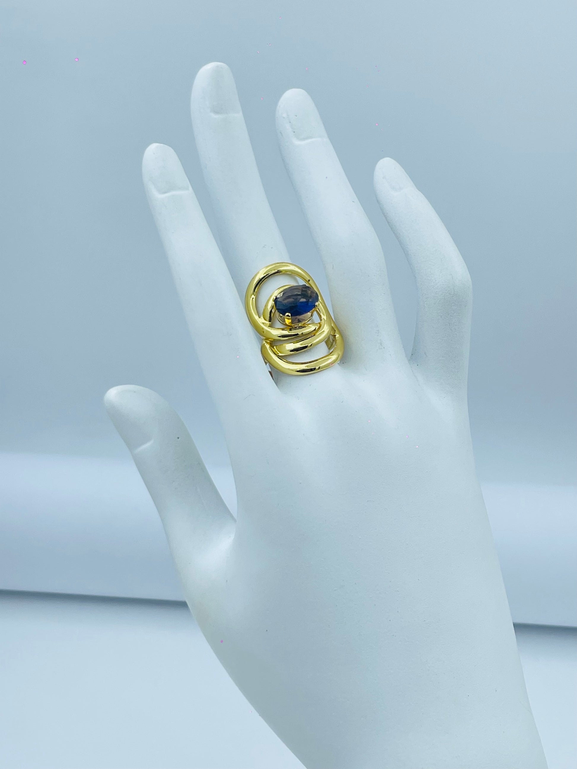 Elegant Gold Spiral Ring with Blue Gemstone