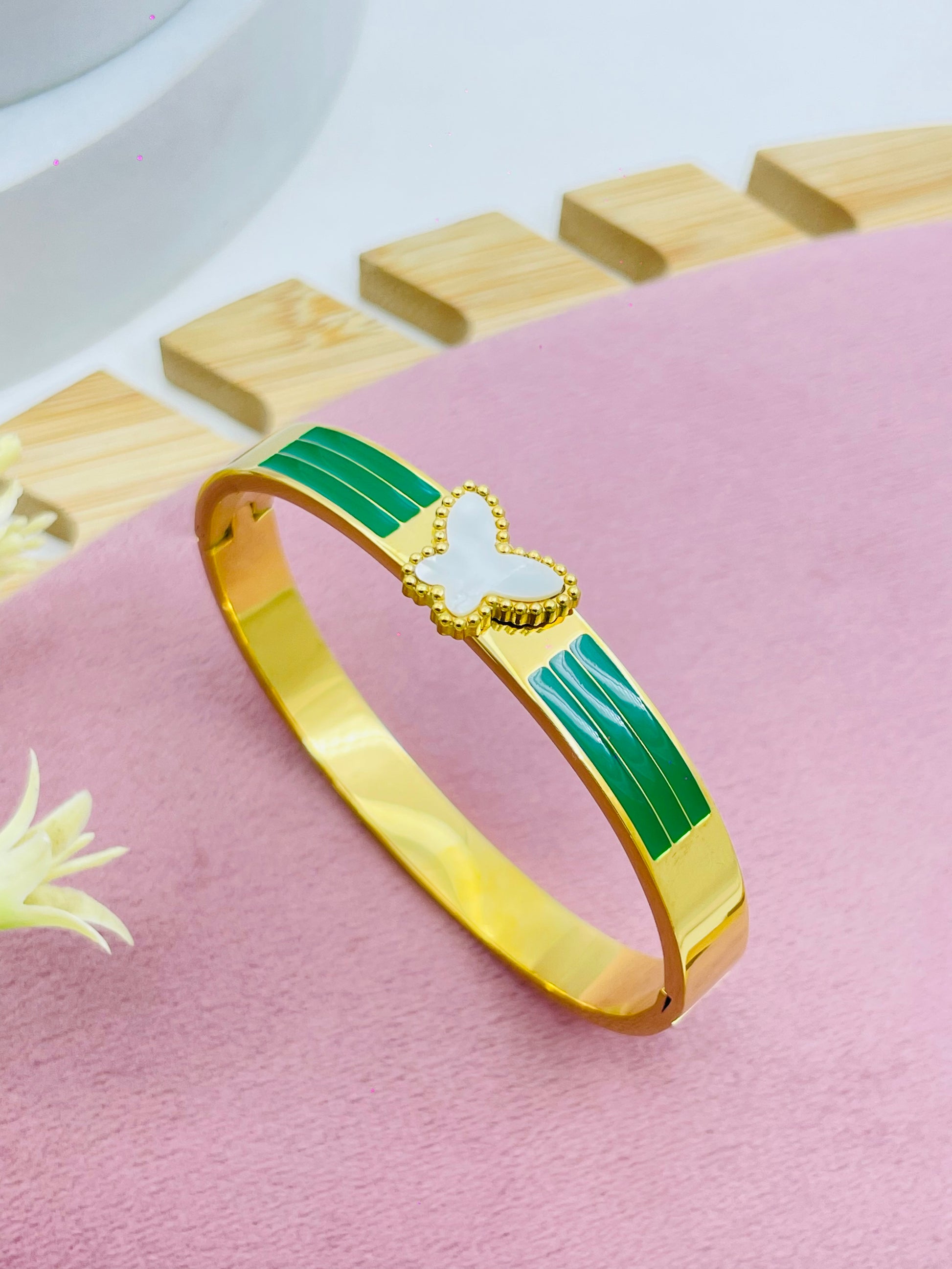 Elegant Gold Bracelet with Butterfly Accent and Green Insets