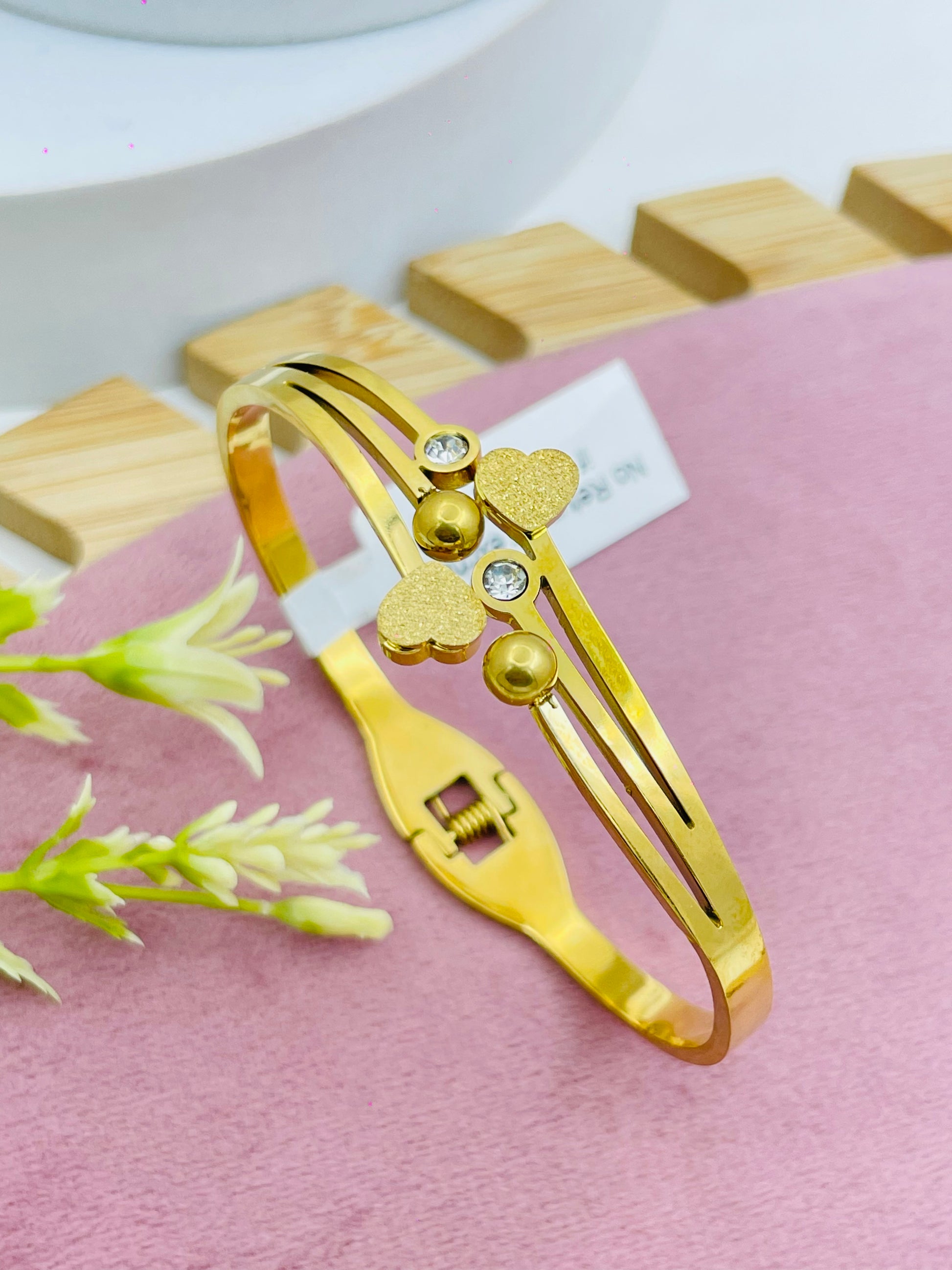 Elegant Gold Bangle with Heart and Crystal Detail