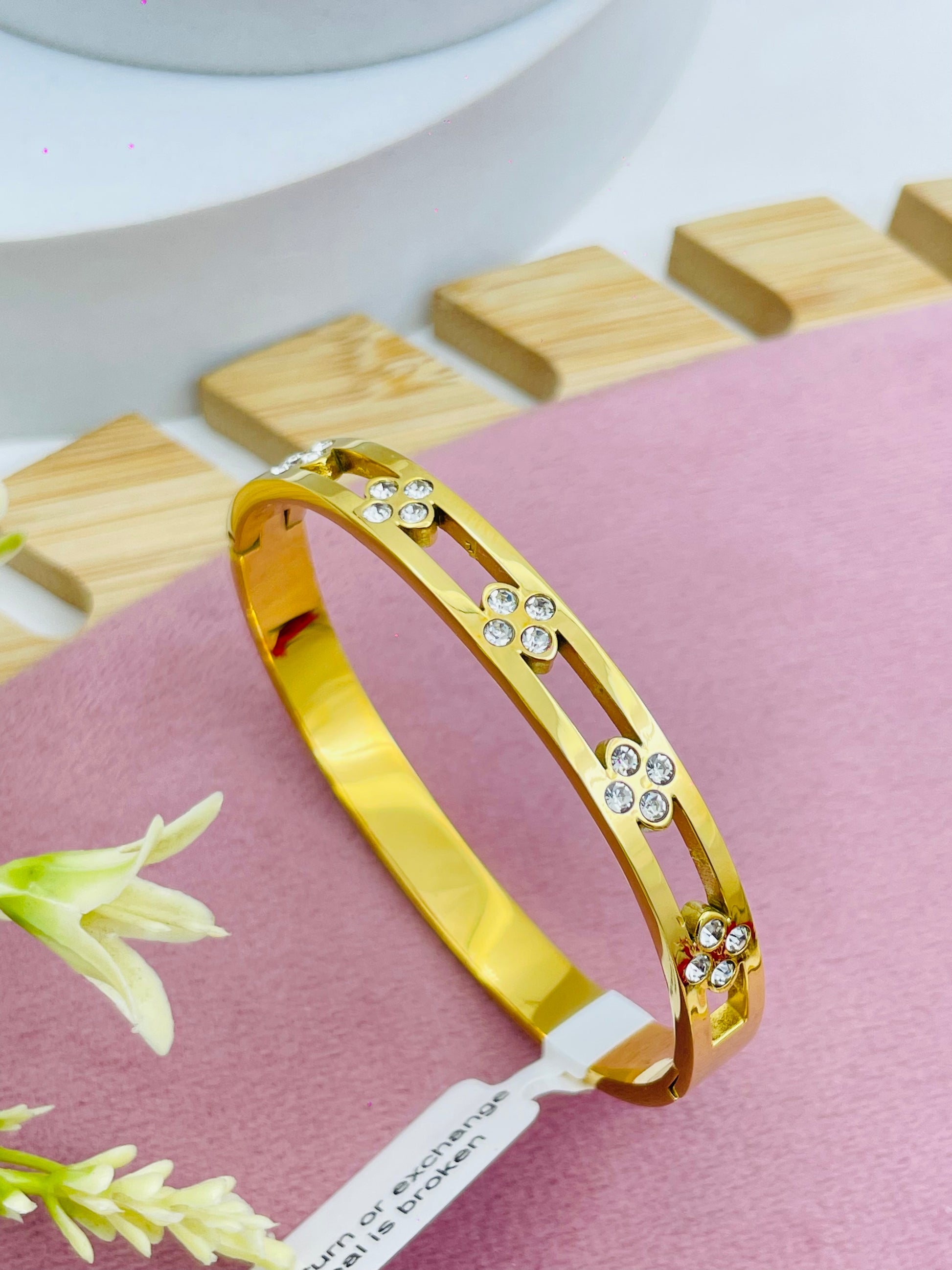 Elegant Gold Floral Bangle with Crystal Accents