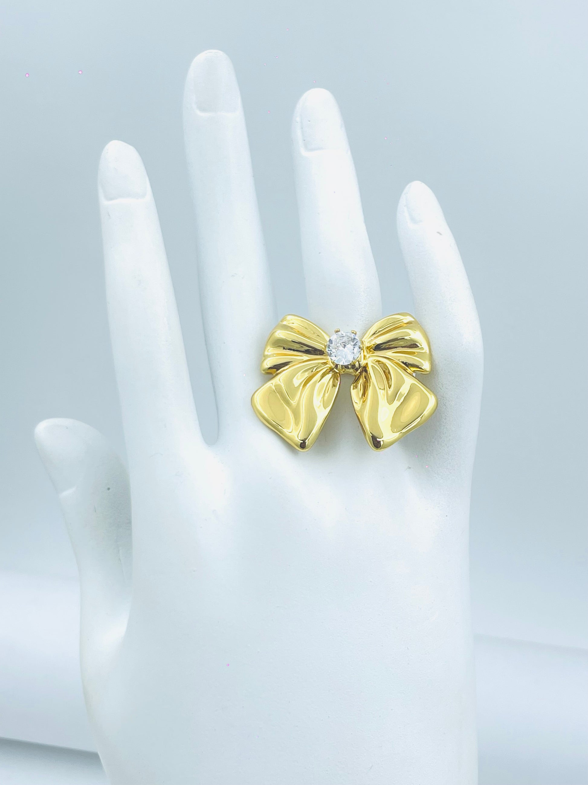 Elegant Gold Bow Ring with Sparkling Center Stone