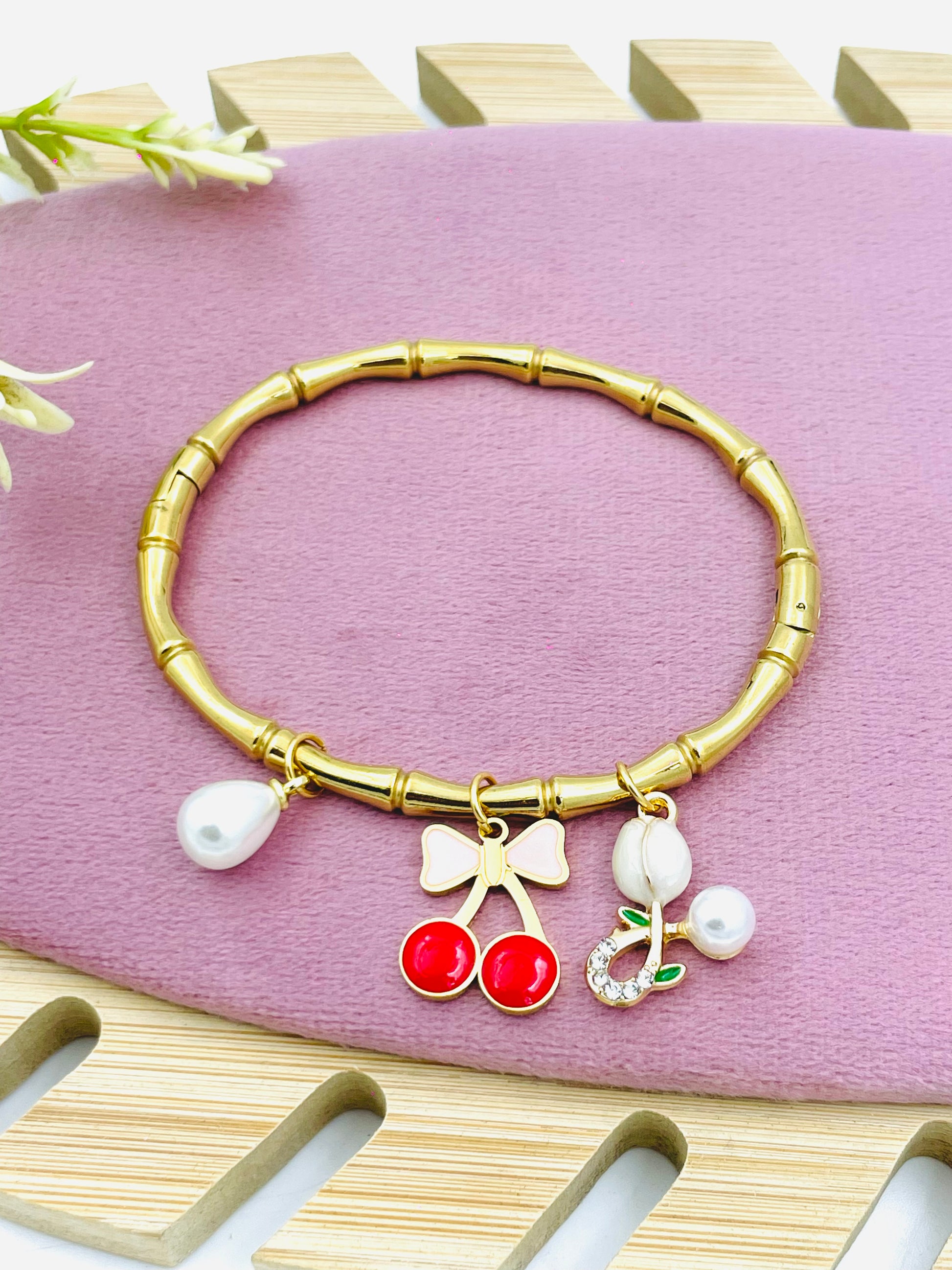 Stylish Gold Bamboo Charm Bracelet with Decorative Charms