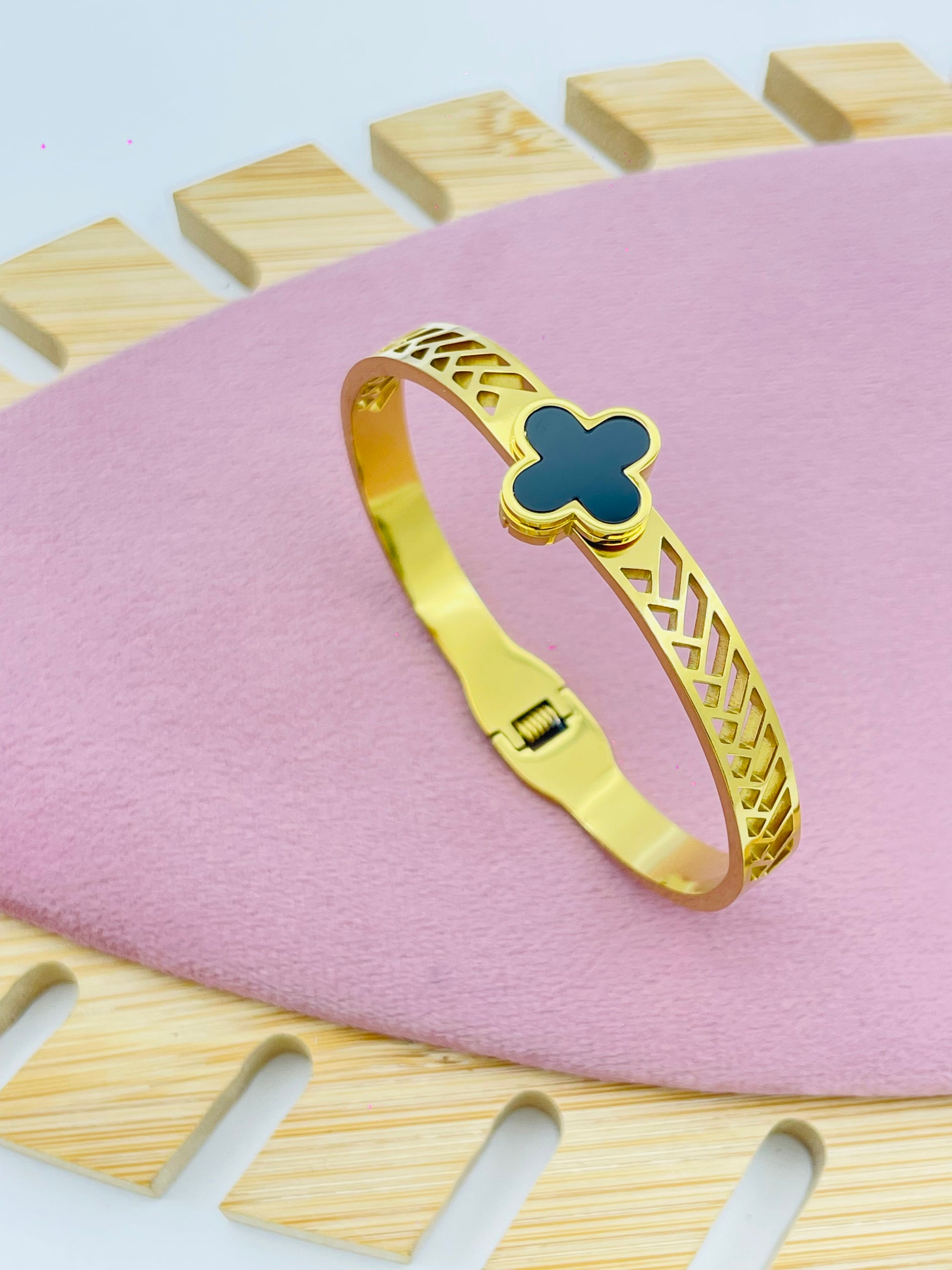 Modern Gold Bangle Bracelet with Black Clover Accent
