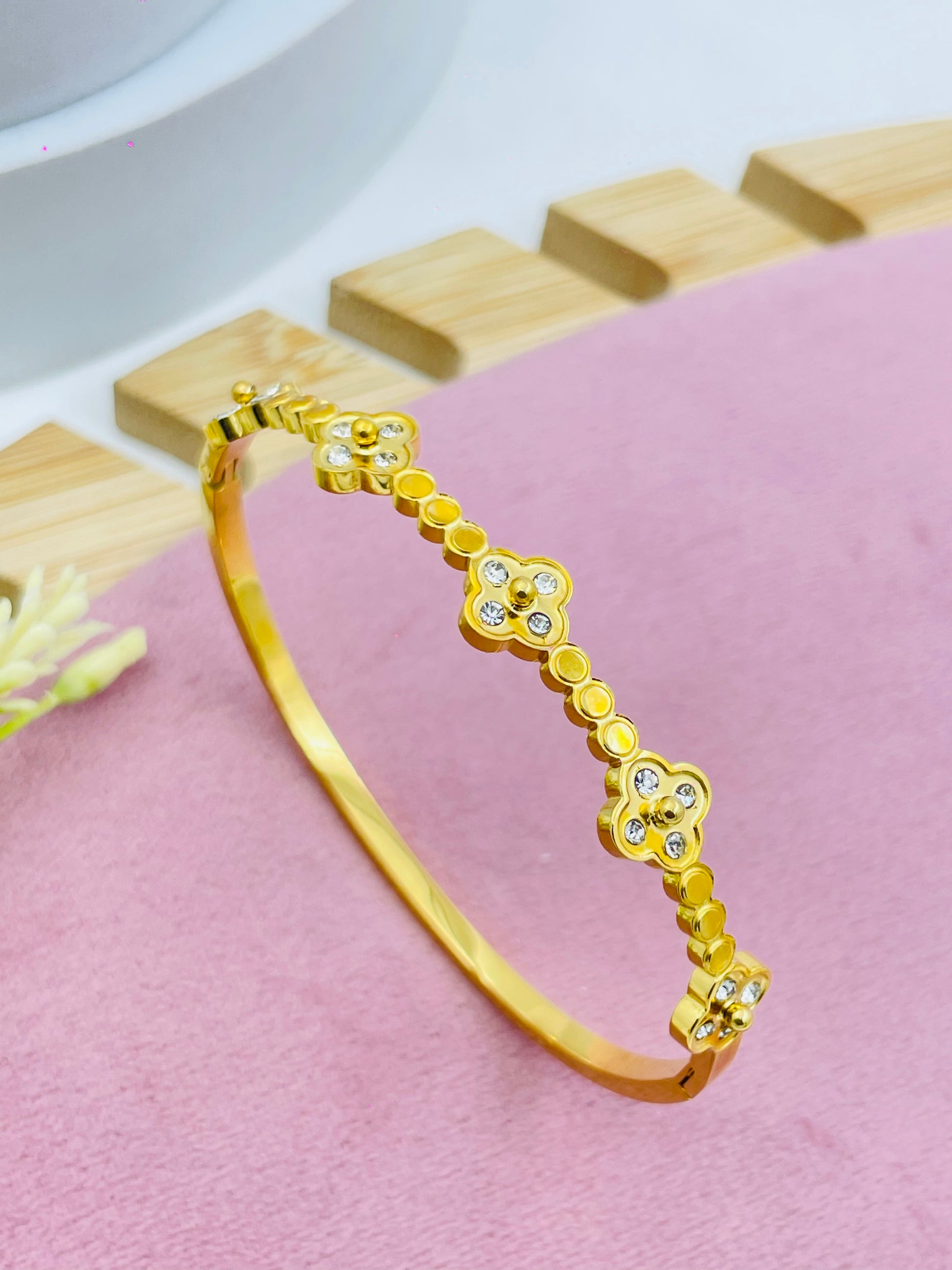 Elegant Gold Tone Floral Bangle with Crystal Accents