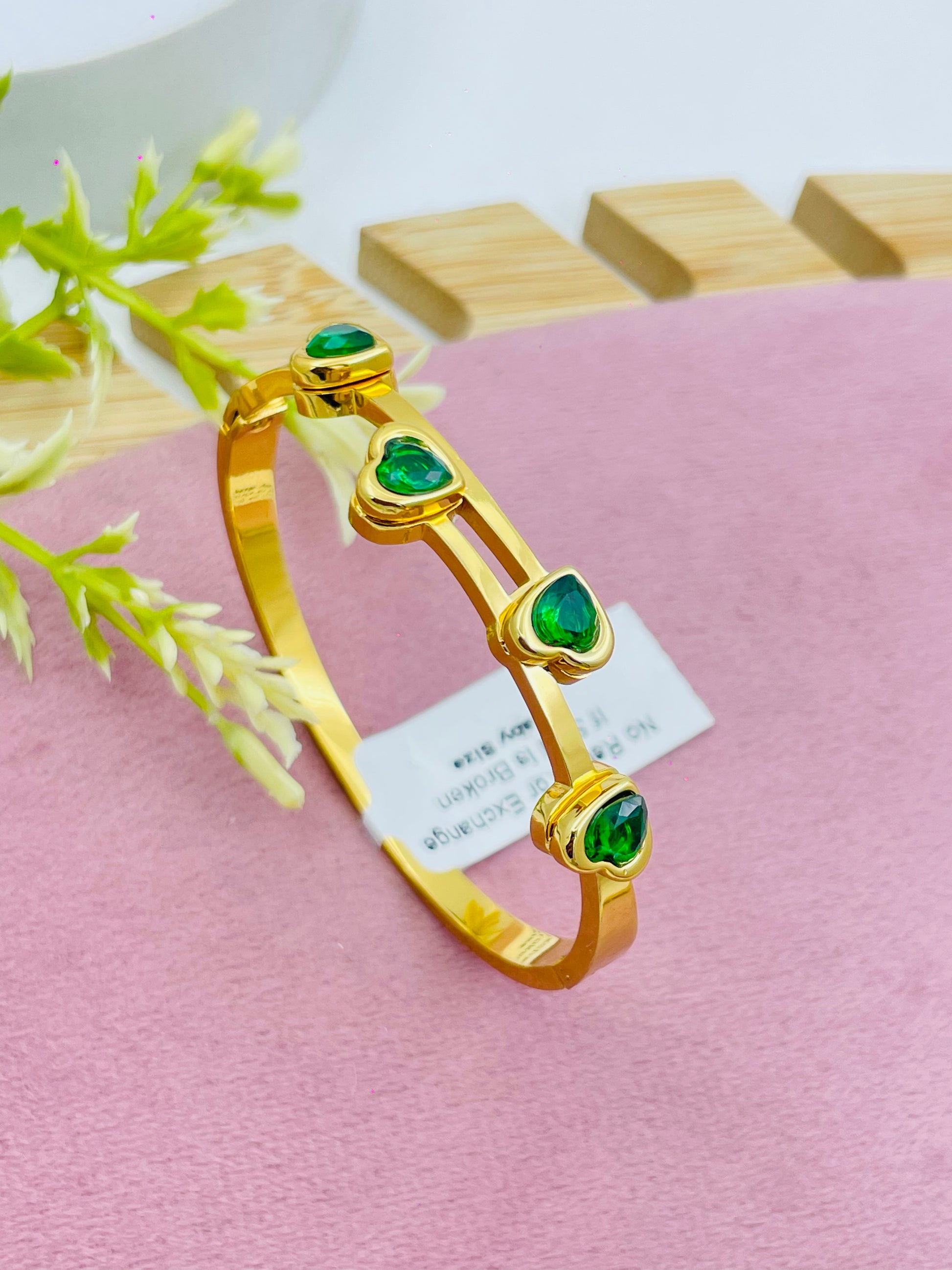 Elegant Gold Band with Green Gemstones