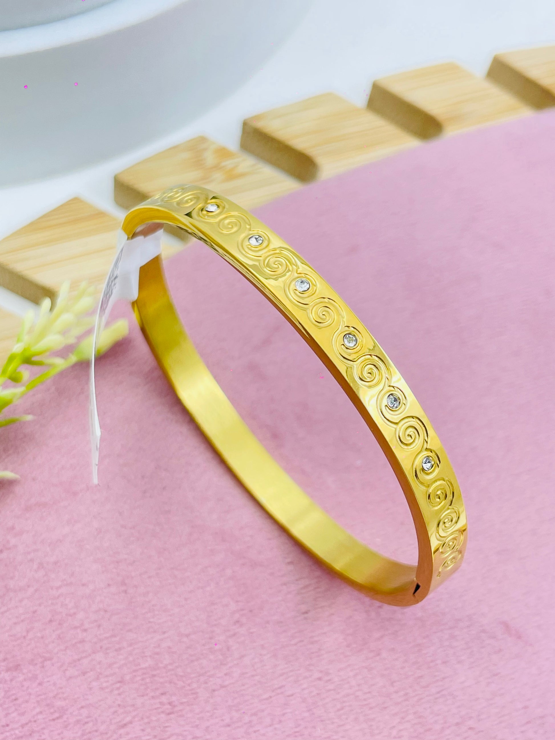 Elegant Gold Plated Spiral Bangle with Stone Details