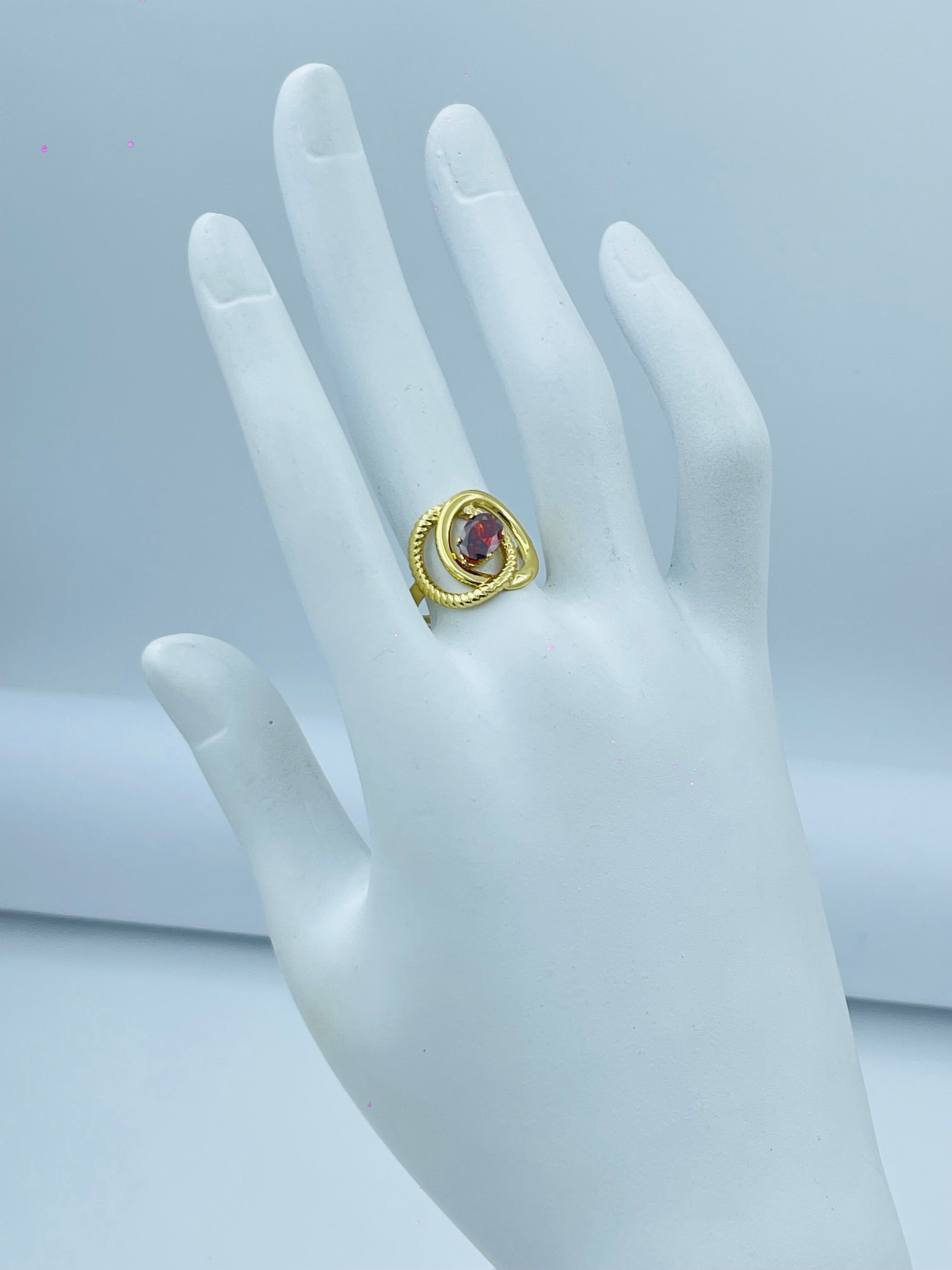 Elegant Gold Spiral Ring with Red Gemstone