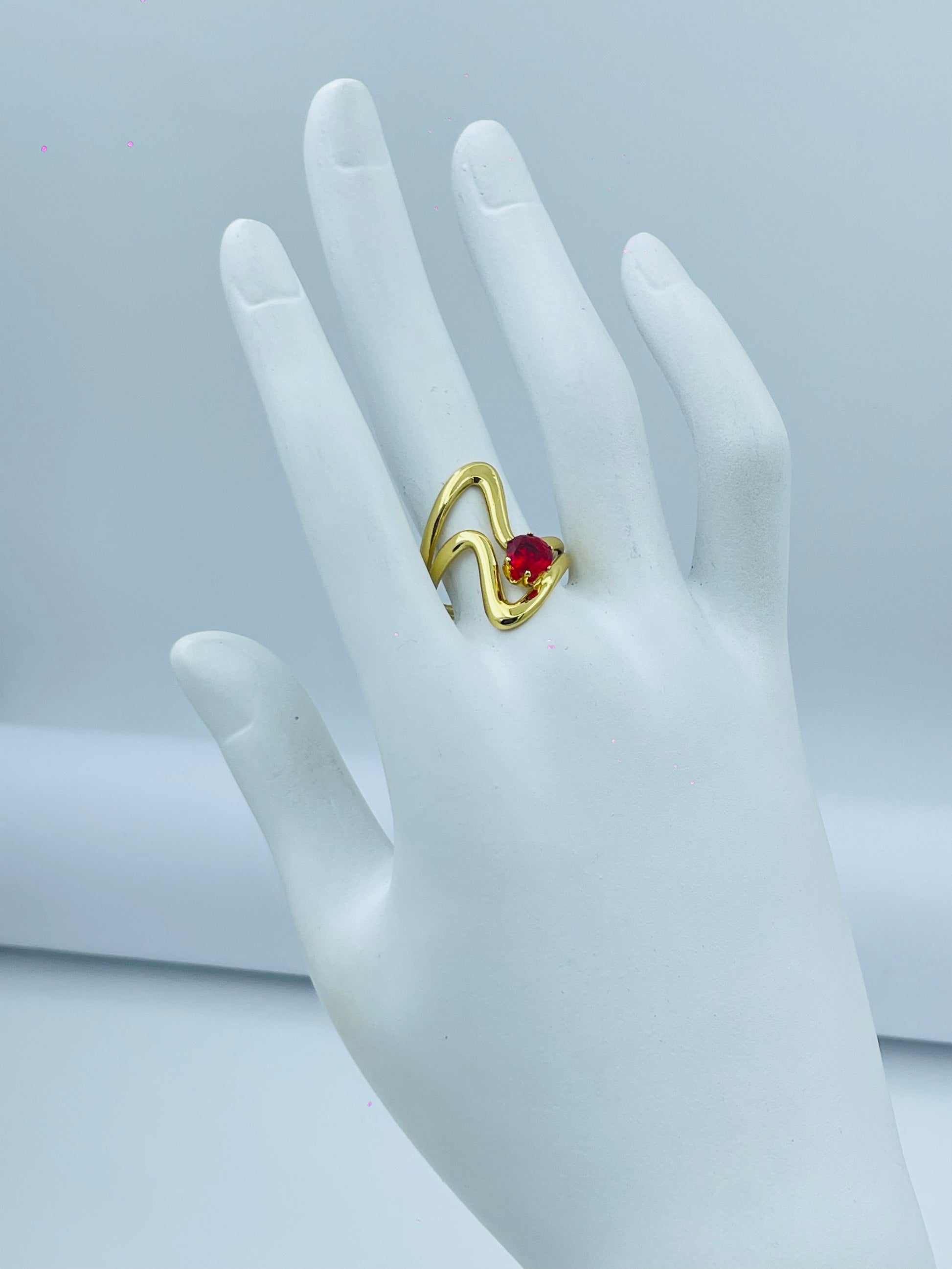 Elegant Gold Wave Ring with Red Gemstone