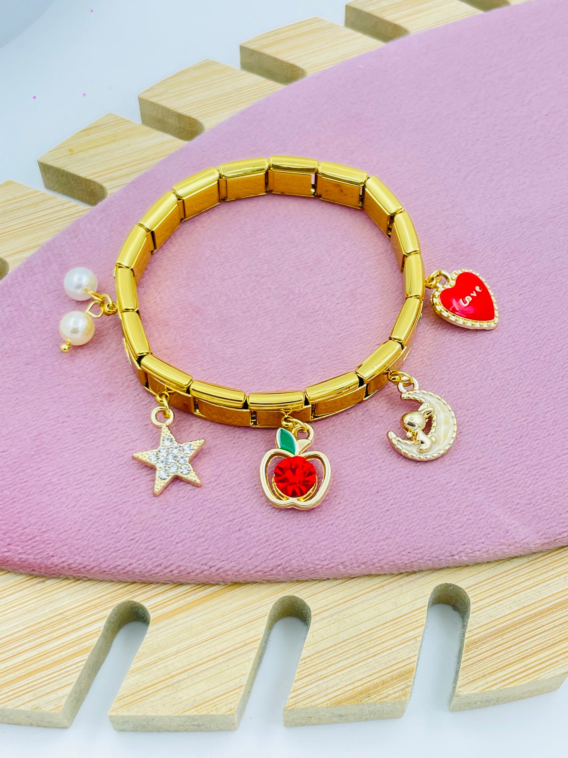 Elegant Gold Charm Bracelet with Iconic Charms