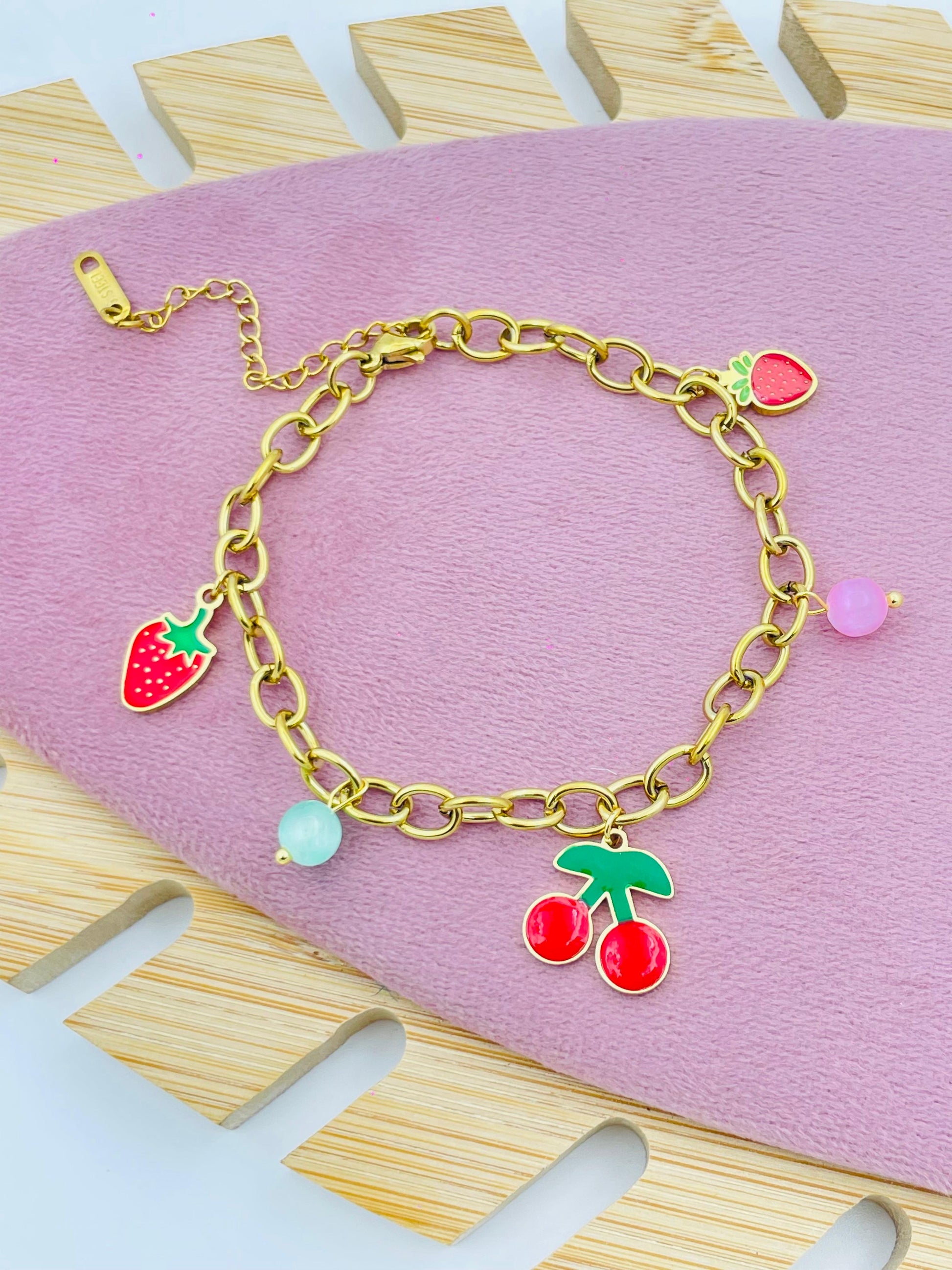 Elegant Gold Pearl Charm Bracelet with Red and Green Accents