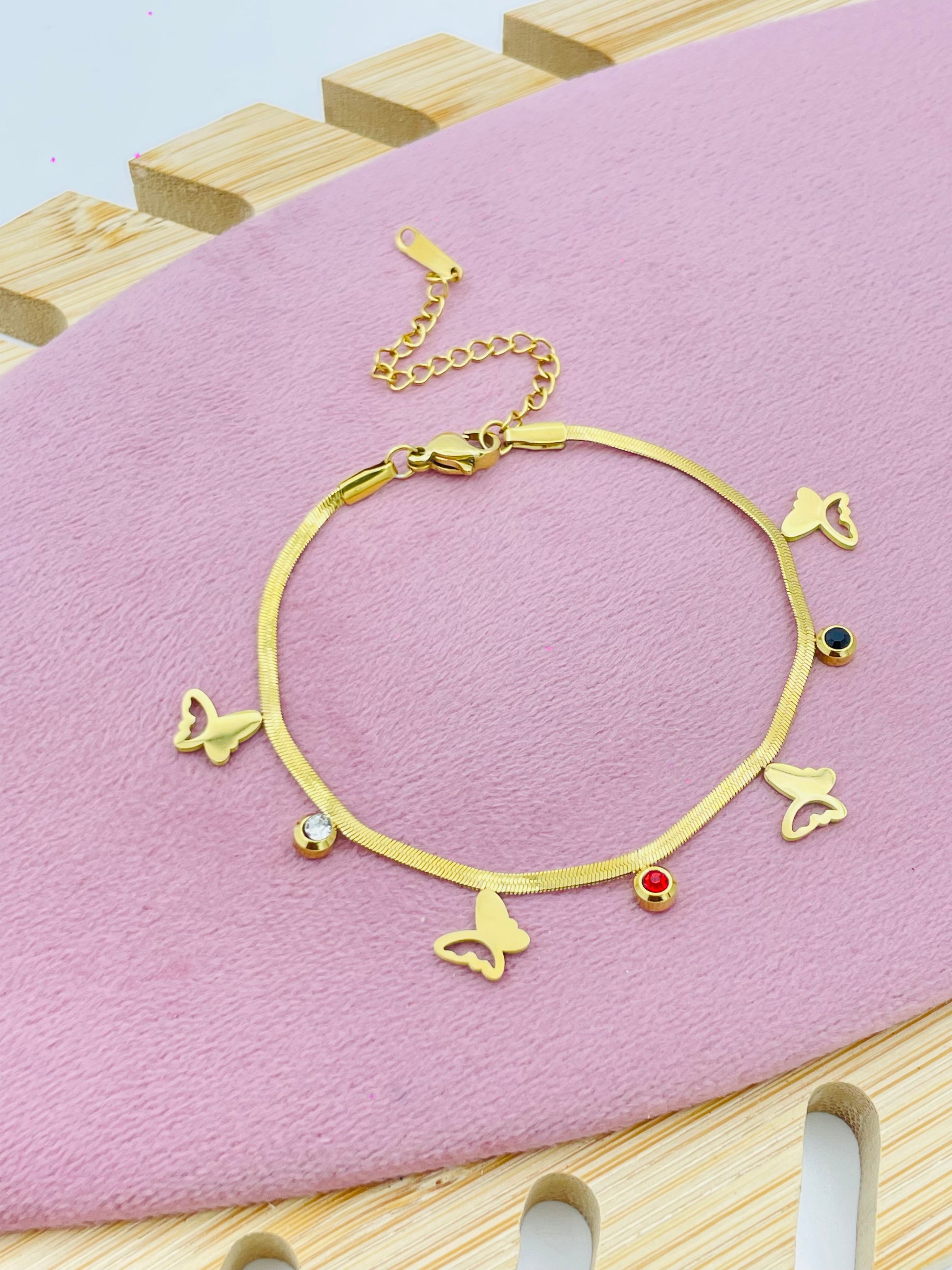 Elegant Gold Charm with Butterfly and Gem Accents