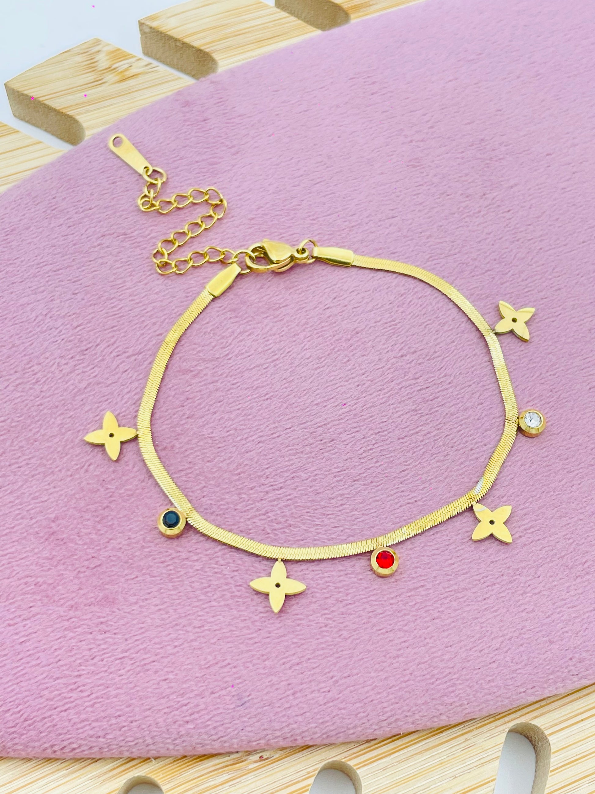 Elegant Gold Bracelet with Star and Gemstone Charms